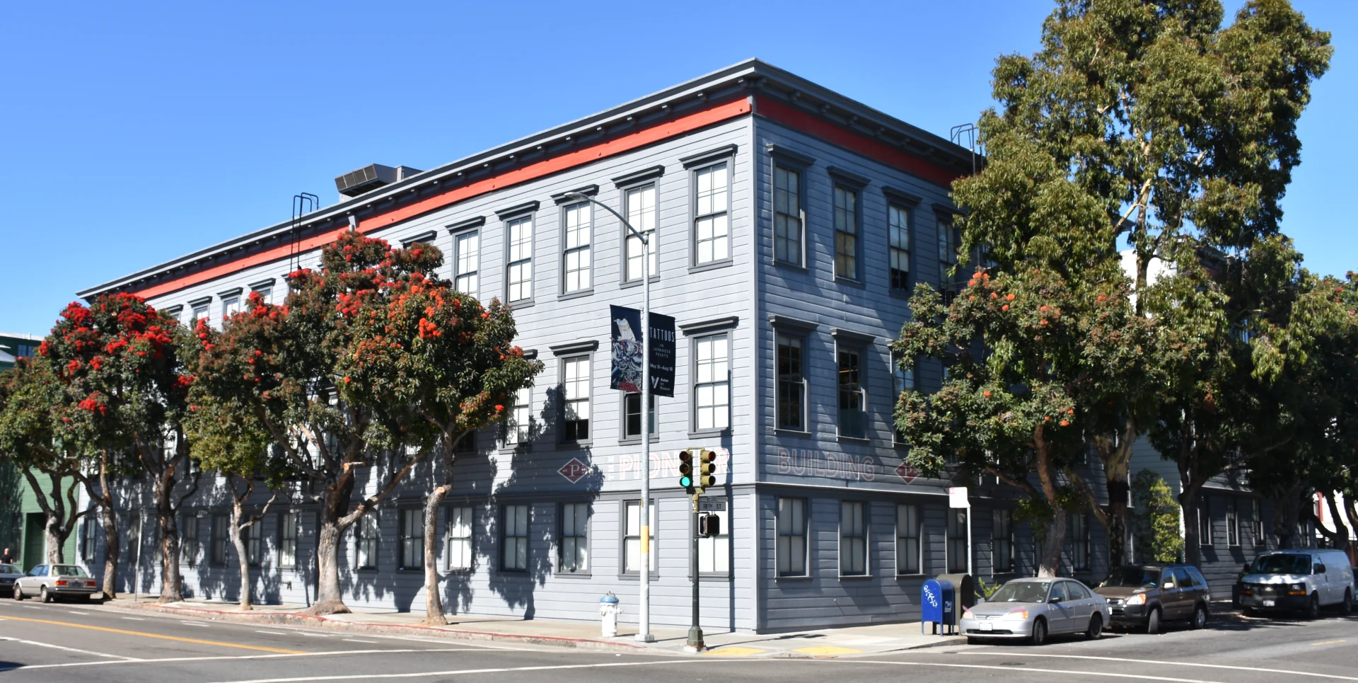 The Pioneer Building’s gray facade and flowering trees in San Francisco.